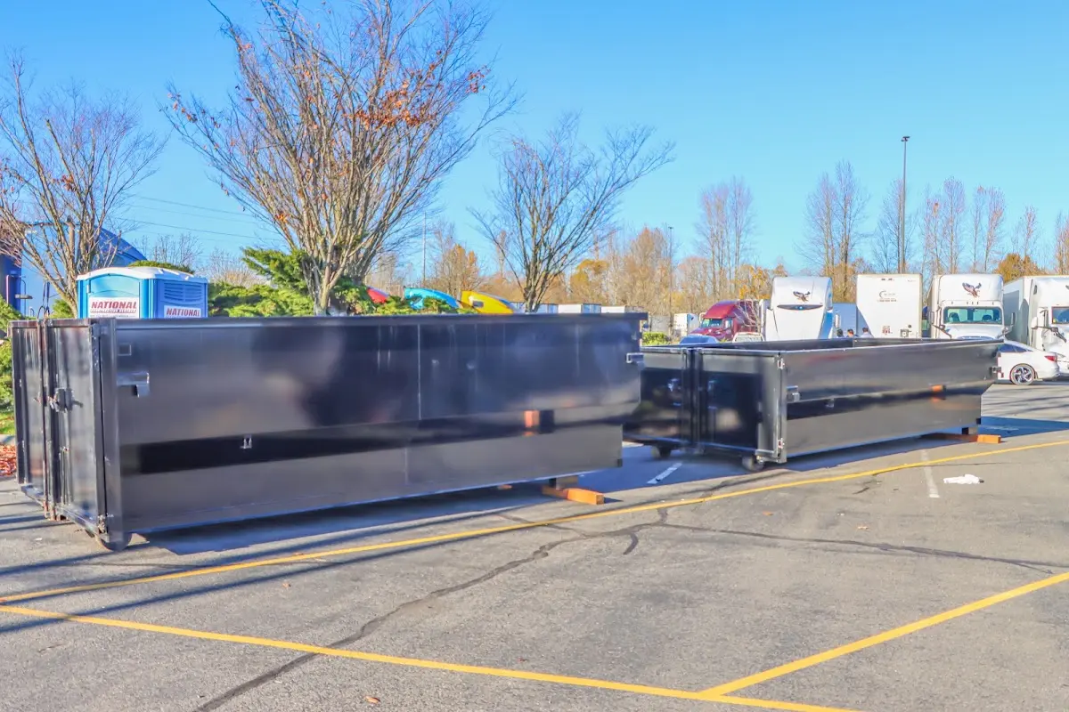 Professional dumpster rental service with roll-off container on residential driveway in Bellingham